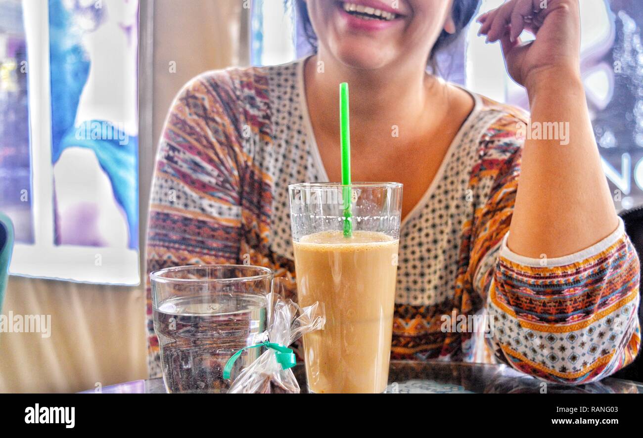 A person drinking coffee at a bar Stock Photo
