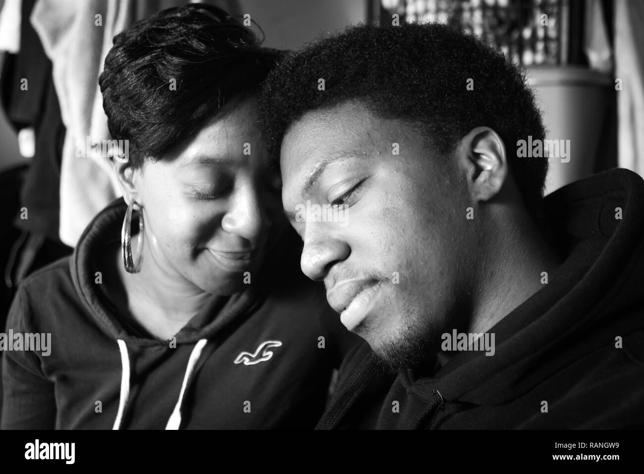 Black mother and son at home having a close moment on the couch Stock Photo