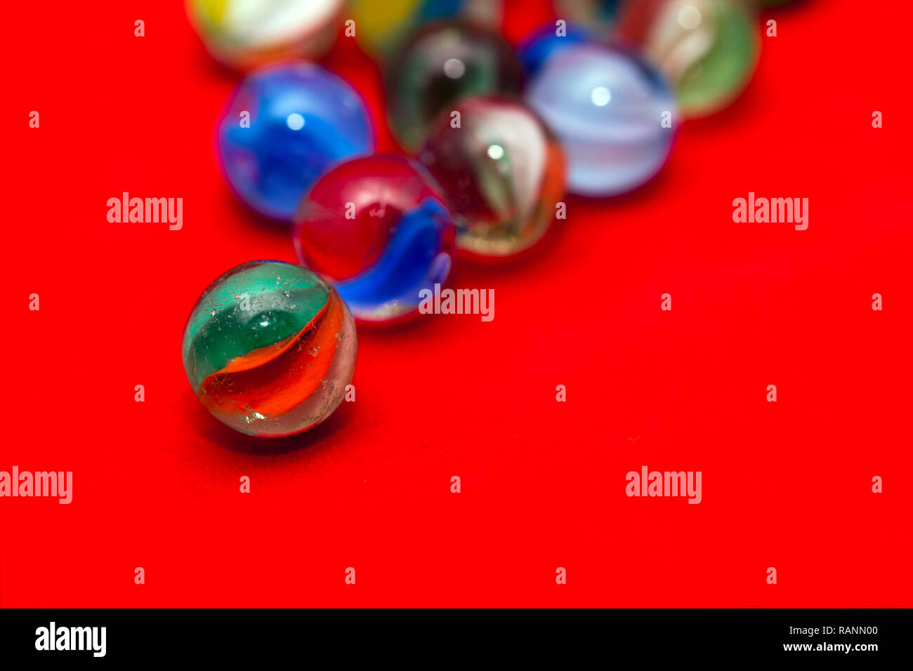 fun game for kids with colored glass marbles, glass balls Stock Photo -  Alamy