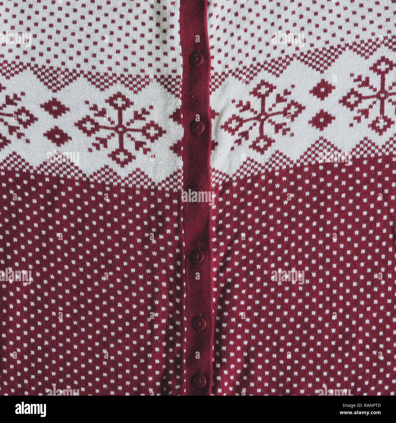 Knitted woolen background. white and red knitted Norwegian pattern. Stock Photo