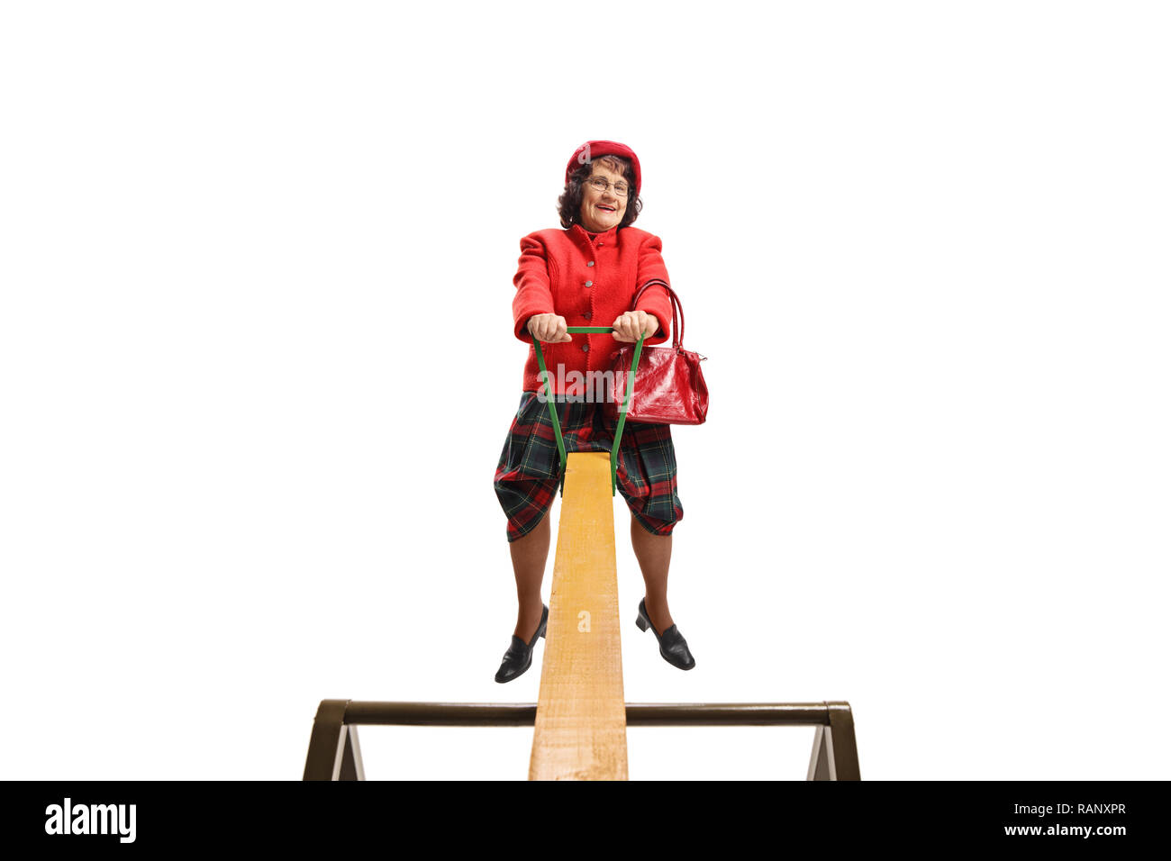 Elderly woman on a seesaw isolated on white background Stock Photo