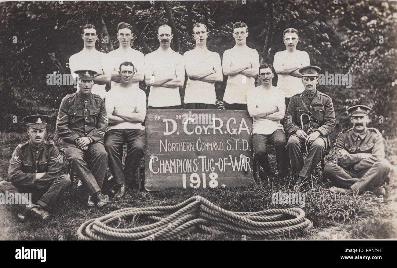 Vintage Photographic Postcard Showing British WW1 Soldiers. The 'D' Coy, R.G.A. Northern Command S.T.D. The Tug-of-War Champions 1918. Stock Photo