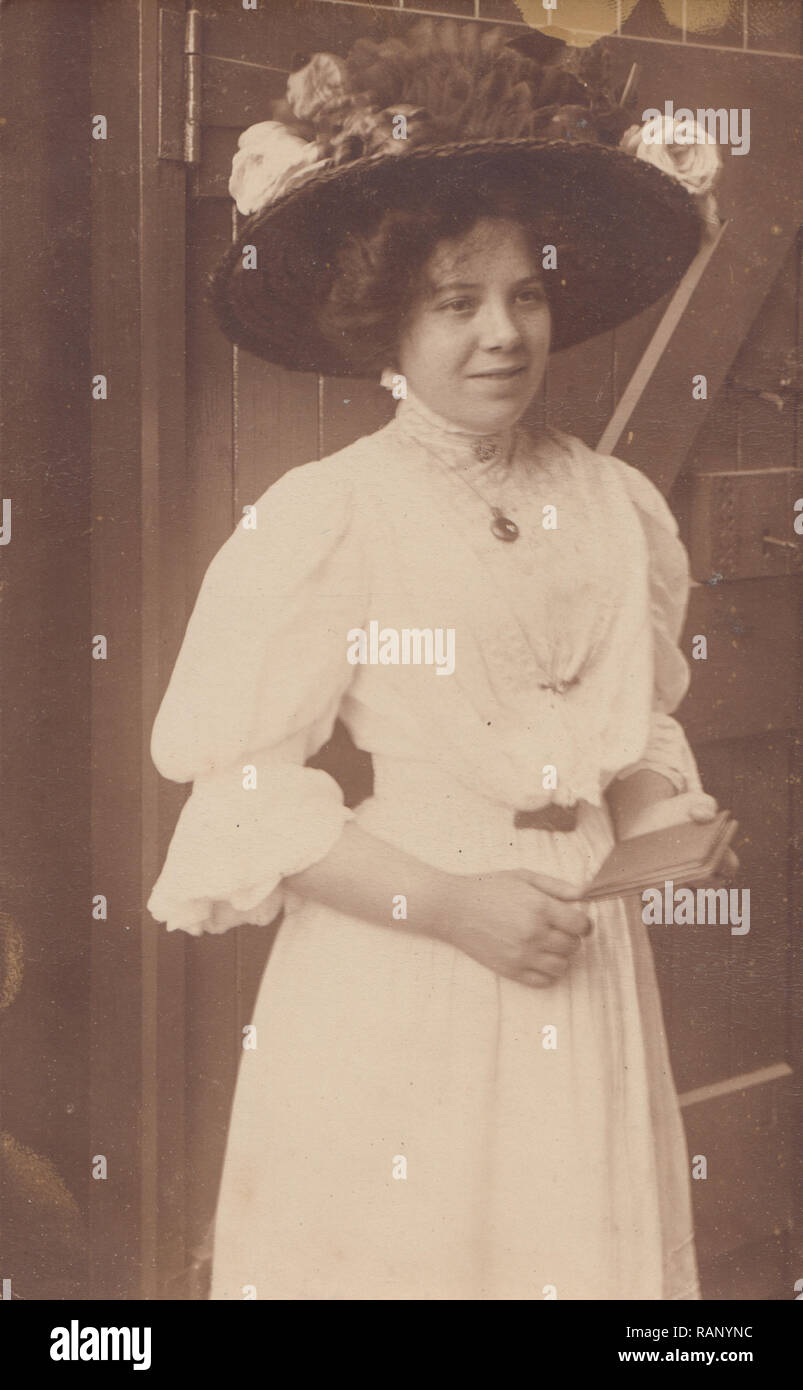 Vintage Photographic Postcard of an Elegant Edwardian Lady Wearing a Large Fancy Hat. Stock Photo