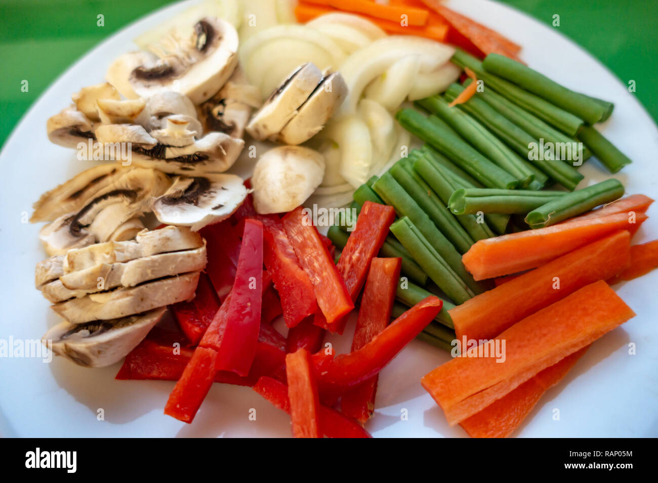 A plain head on shot of Raw uncooked but prepared 5 A Day vegetable portions on one plate Stock Photo