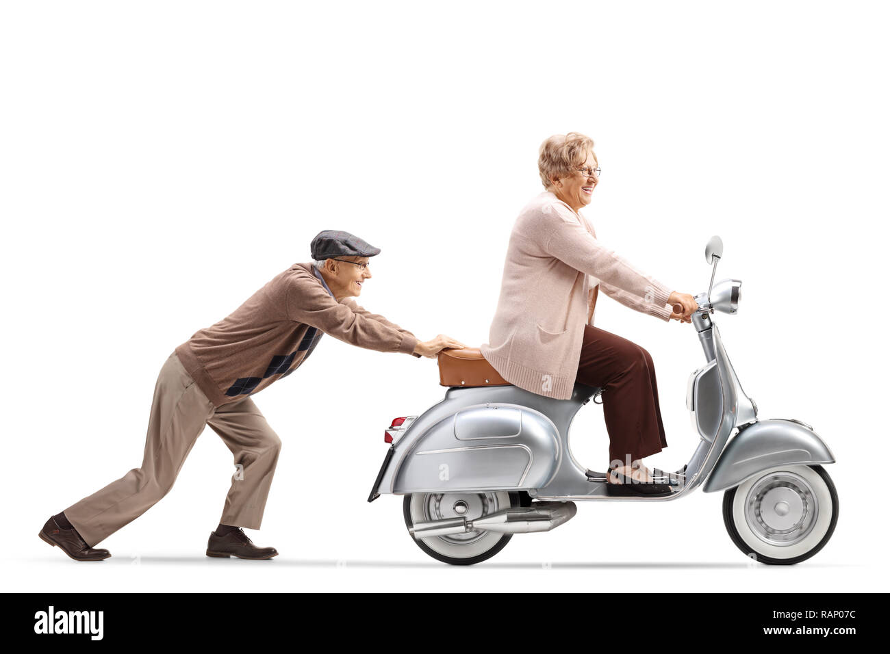 Full length shot of a senior man pushing a smiling senior woman riding a vintage scooter isolated on white background Stock Photo