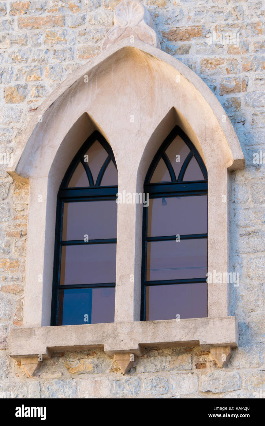 Antique window disign of the Catholic church of St. John the Baptist - the oldest of the fortified old city of Budva, Montenegro (dates back to the 7t Stock Photo