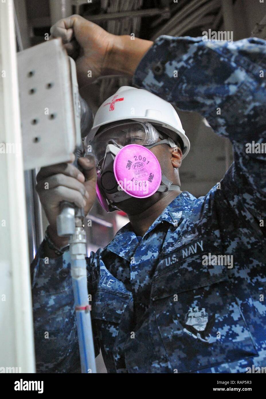 YOKOSUKA, Japan (Feb. 22, 2017) - Hospital Corpsman 3rd Class Patrick Gayle from Jacksonville, Fla., attached to the U.S. 7th Fleet flagship USS Blue Ridge (LCC 19), sands a door frame in the ship's medical waiting area. Blue Ridge is in an extensive maintenance period in order to modernize the ship to continue to serve as a robust communications platform in the U.S. 7th Fleet area of operations. Stock Photo