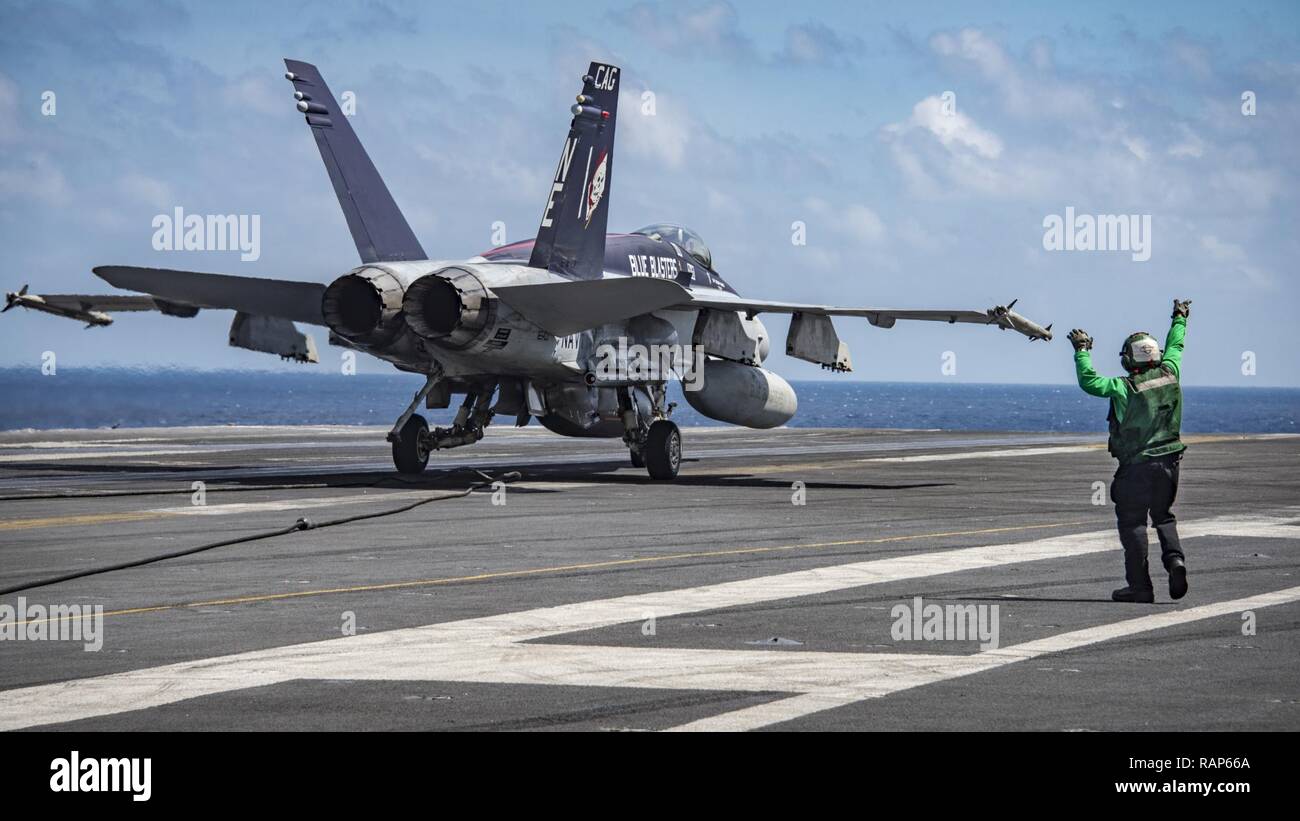 SOUTH CHINA SEA (Feb. 23, 2017) An F/A-18E Super Hornet assigned to the “Blue Blasters” of Strike Fighter Squadron (VFA) 34  makes an arrested landing aboard the aircraft carrier USS Carl Vinson (CVN 70). The ship and its carrier strike group is on a western Pacific deployment as part of the U.S. Pacific Fleet-led initiative to extend the command and control functions of U.S. 3rd Fleet. Stock Photo