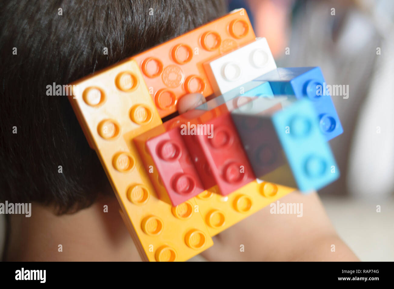 Boy playing with lego construction toy blocks. Stock Photo