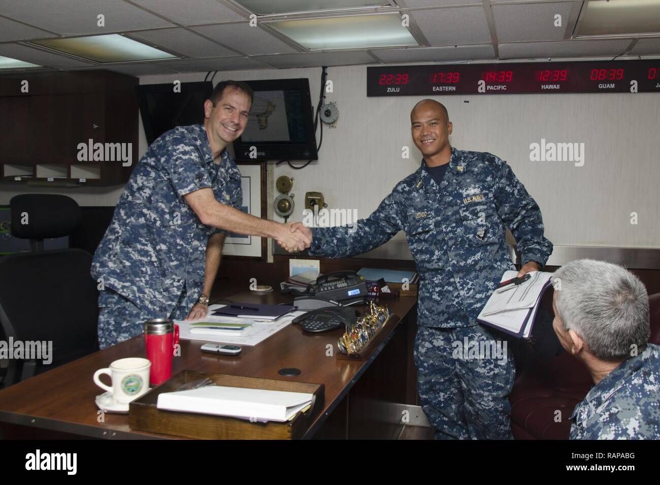 SANTA RITA, Guam - The submarine tender USS Frank Cable (AS 40) Commanding Officer Capt. Drew St. John congratulated Chief Damage Controlman Cyprus V. Abundo, native of Angeles City, Philippines, for his selection as the winner of the 2016 GEICO Military Service Award - Fire Safety and Prevention, Feb. 10.  Frank Cable, forward deployed to the island of Guam, conducts maintenance and support of submarines and surface vessels deployed to the U.S. 5th and 7th Fleet area of operations. Stock Photo