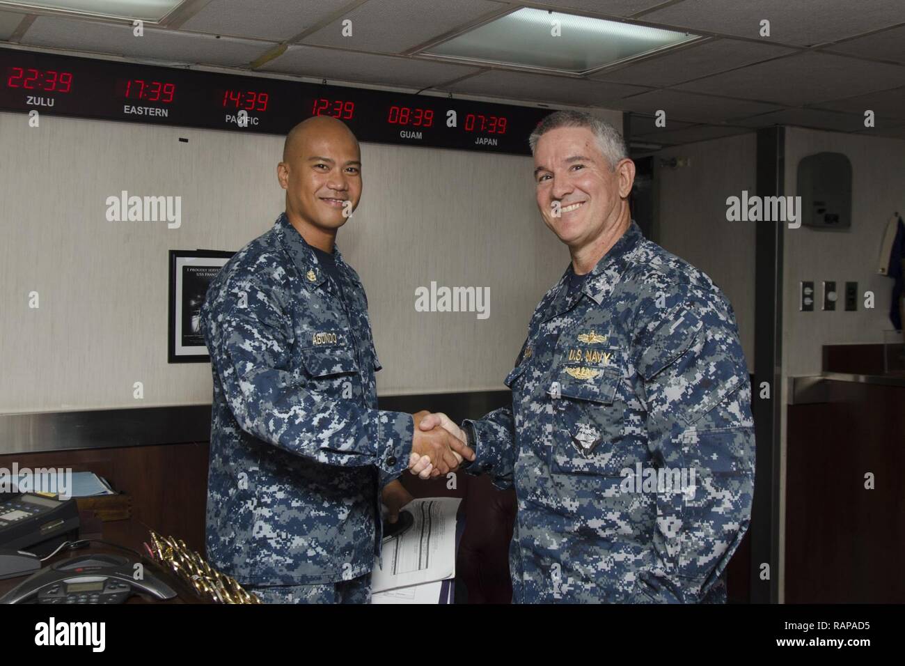 SANTA RITA, Guam - The submarine tender USS Frank Cable (AS 40) Executive Officer Cmdr. Ed Callahan congratulated Chief Damage Controlman Cyprus V. Abundo, native of Angeles City, Philippines, for his selection as the winner of the 2016 GEICO Military Service Award - Fire Safety and Prevention, Feb. 10.  Frank Cable, forward deployed to the island of Guam, conducts maintenance and support of submarines and surface vessels deployed to the U.S. 5th and 7th Fleet area of operations. Stock Photo