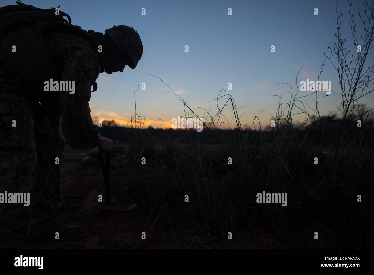 Builder 2nd Class Brandon Rowe, from Rochester, NY., maintains a fighting postion during a field training exercise with Naval Mobile Construction Battalion (NCB) 133. Seabees around the world will take part in a year-long celebration in 2017 to commemorate the group's 75-year anniversary in March. The theme of the celebration is 'Built on History, Constructing the Future. Stock Photo