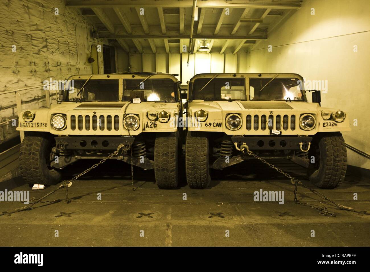 Humvees are staged on the USNS Mendonca at Shuaiba Port, Kuwait, on Feb. 28, 2017. The Mendonca is used to import and export U.S. Military vehicles in support of operations in the USCENTCOM AOR. Stock Photo