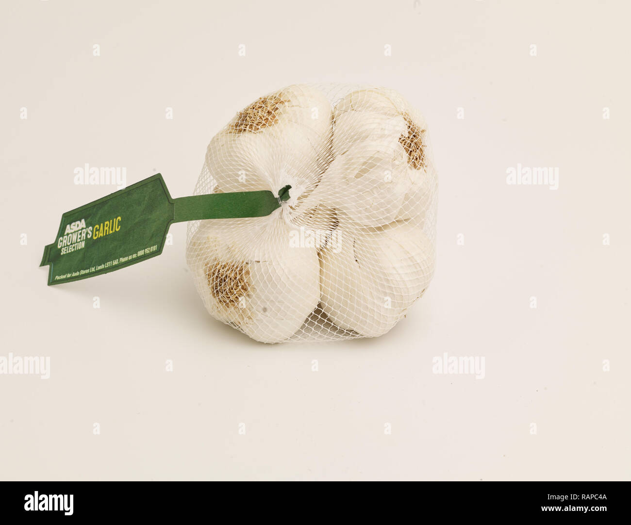 Garlic in net bag on white background food photograph Stock Photo