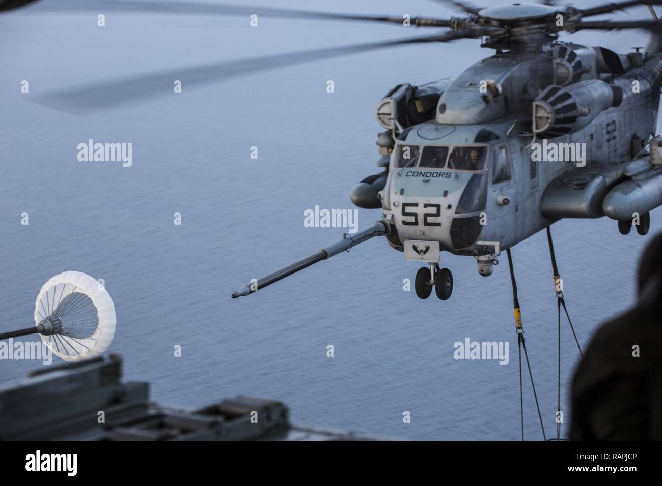 U.S. Marines assigned to Marine Heavy Helicopter Squadron conduct an aerial refuel training operation with Marine Aerial Refueler Transport Squadron (VMGR) 234 on Feb. 23, 2017. VMGR-234 assisted HMH-464 in the training to maintain interoperability. Stock Photo