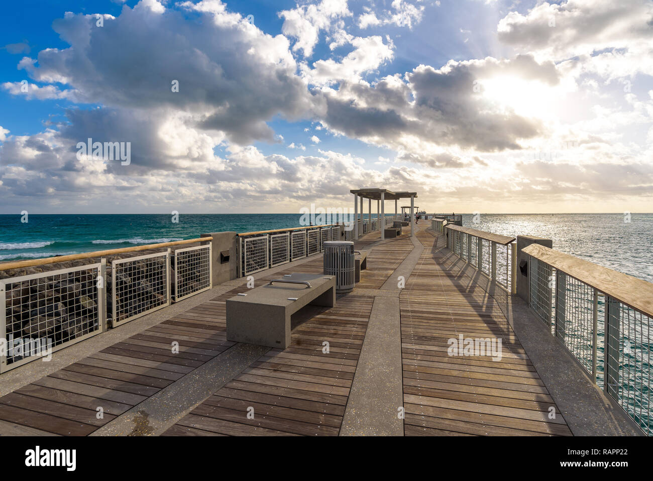 Open view over the Atlantic ocean from South Pointe Pier at sunrise, with waves crashing on breakwater. Miami Beach, Florida. Stock Photo