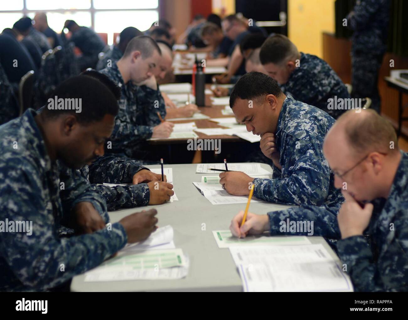 ANTA RITA, Guam (March 2, 2017) – Second class petty officers, assigned to the submarine tender USS Frank Cable (AS 40), take the Navy-wide E-6 advancement exam at Naval Base Guam, March 2.  Frank Cable is forward-deployed to the island of Guam and conducts maintenance and support of submarines and surface vessels deployed to the U.S. 5th and 7th Fleet area of operations. Stock Photo