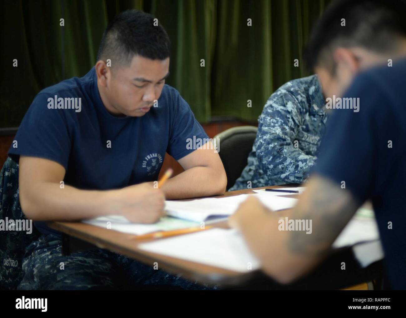 ANTA RITA, Guam (March 2, 2017) – Boatswain’s Mate 2nd Class Delmar Castro, assigned to the submarine tender USS Frank Cable (AS 40) and native of Sacramento, Calif., takes the Navy-wide E-6 advancement exam at Naval Base Guam, March 2.  Frank Cable is forward-deployed to the island of Guam and conducts maintenance and support of submarines and surface vessels deployed to the U.S. 5th and 7th Fleet area of operations. Stock Photo