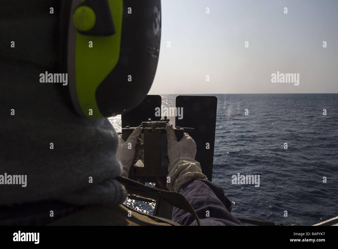 EAST CHINA SEA (March 4, 2017) Electronics Technician 3rd Class Gregory Grubbs, from Fort Worth, Texas, fires a .50-caliber machine gun during a defense of the amphibious task force (DATF) gunnery exercise aboard the amphibious transport dock ship USS Green Bay (LPD 20). During the DATF exercise, Green Bay’s small caliber action team (SCAT) worked together with Marines from the 31st Marine Expeditionary Unit (MEU) in order to provide 360-degree coverage of the ship. Green Bay, with embarked 31st MEU, is on a routine patrol, operating in the Indo-Asia-Pacific region to enhance partnerships and  Stock Photo