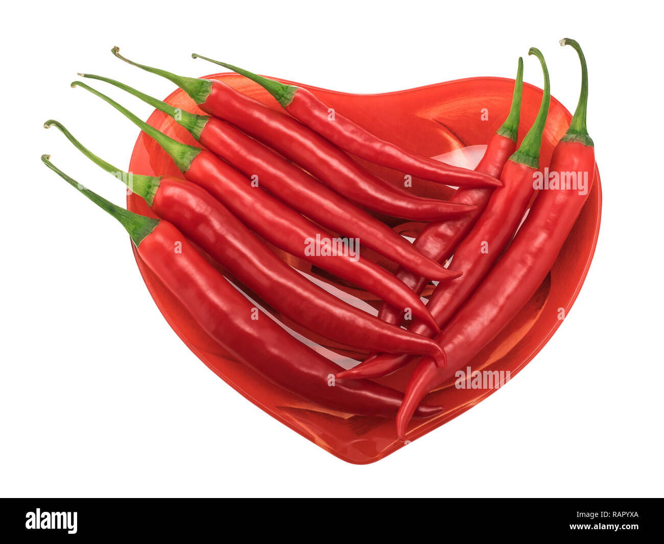 Chilli peppers on a heart-shaped plate Stock Photo