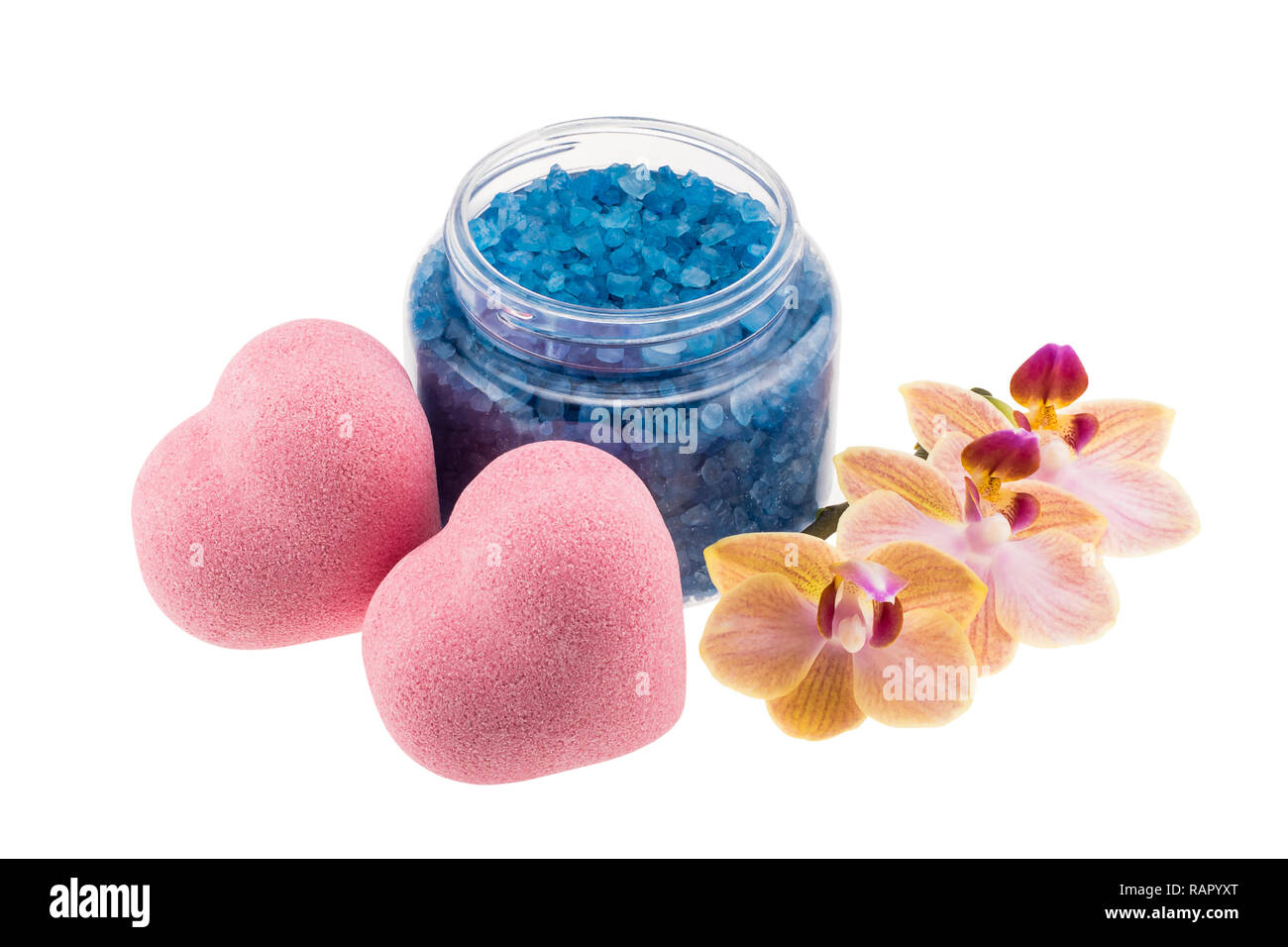 Composition of heart-shaped bath bombs, open bottle with blue sea salt and orchid flower Stock Photo