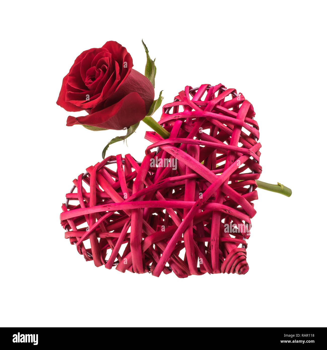 Wicker heart pierced with a red rose Stock Photo