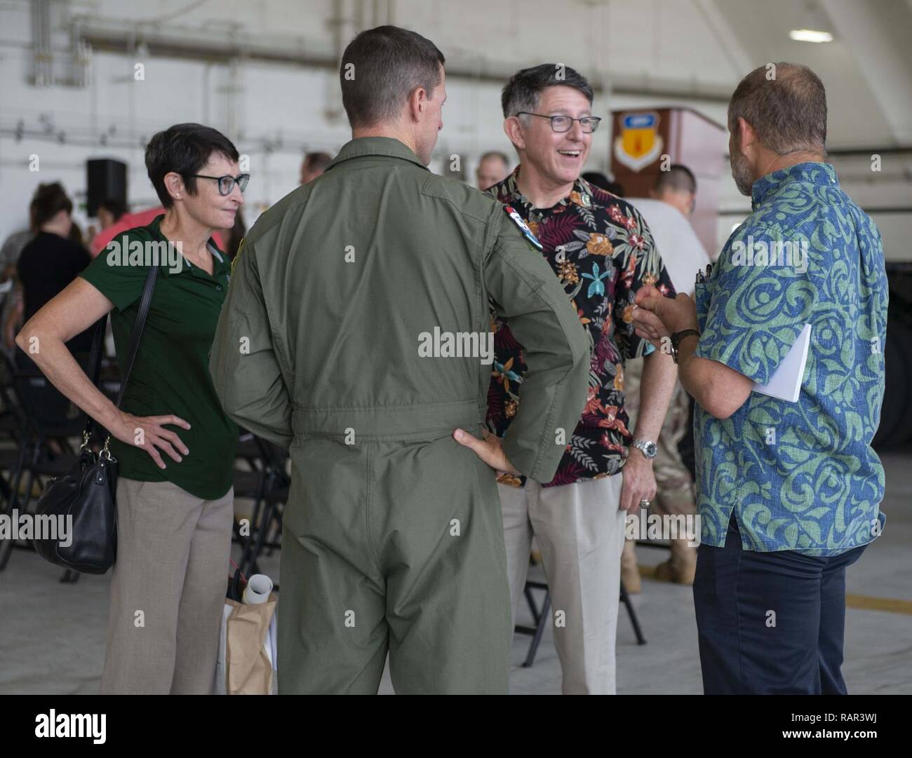 ANDERSEN AIR FORCE BASE, Guam (Dec. 10, 2018) - Thomas Krise, president, University of Guam, third from left, and his wife, far left, engage in conversation during the Operation Christmas Drop Push Ceremony at Andersen Air Force Base Dec. 10.  During the ceremony, the first of nearly 100 boxes of humanitarian goods was pushed into the C-130 before being delivered to 56 islands across the Commonwealth of the Northern Mariana Islands, the FSM and the Republic of Palau. Stock Photo