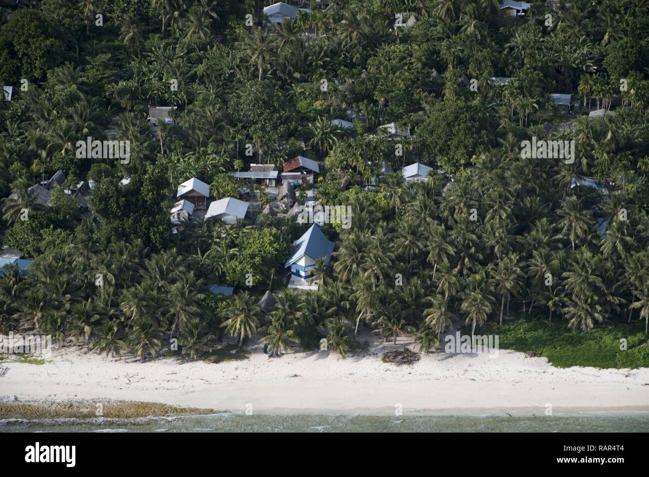 A village on Fais Island, Federated States of Micronesia, anticipates Operation Christmas Drop, Dec. 10, 2018. Fais is an isolated island in the Pacific Ocean located approximately 156 miles northeast of Yap where a C-130J Super Hercules from the 36th Airlift Squadron, Yokota Air Base, Japan, delivered more than 1000 pounds of agricultural equipment, food, clothing, educational and medical supplies to the inhabitants of Fais during Operation Christmas Drop 2018. Stock Photo