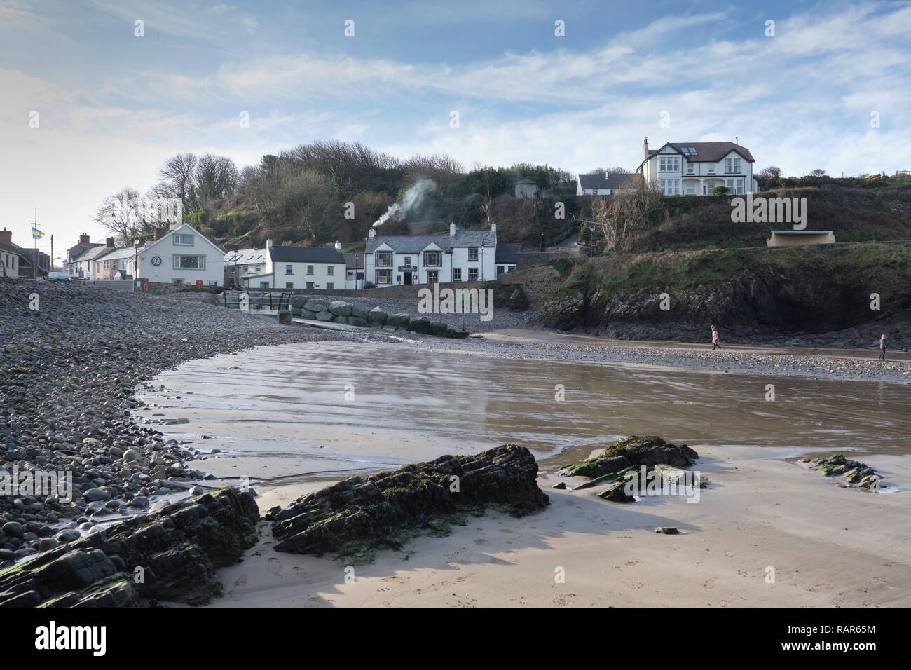 View of The Swan Inn taken from Little Haven beach, Pembrokeshire, Wales in Winter. Stock Photo