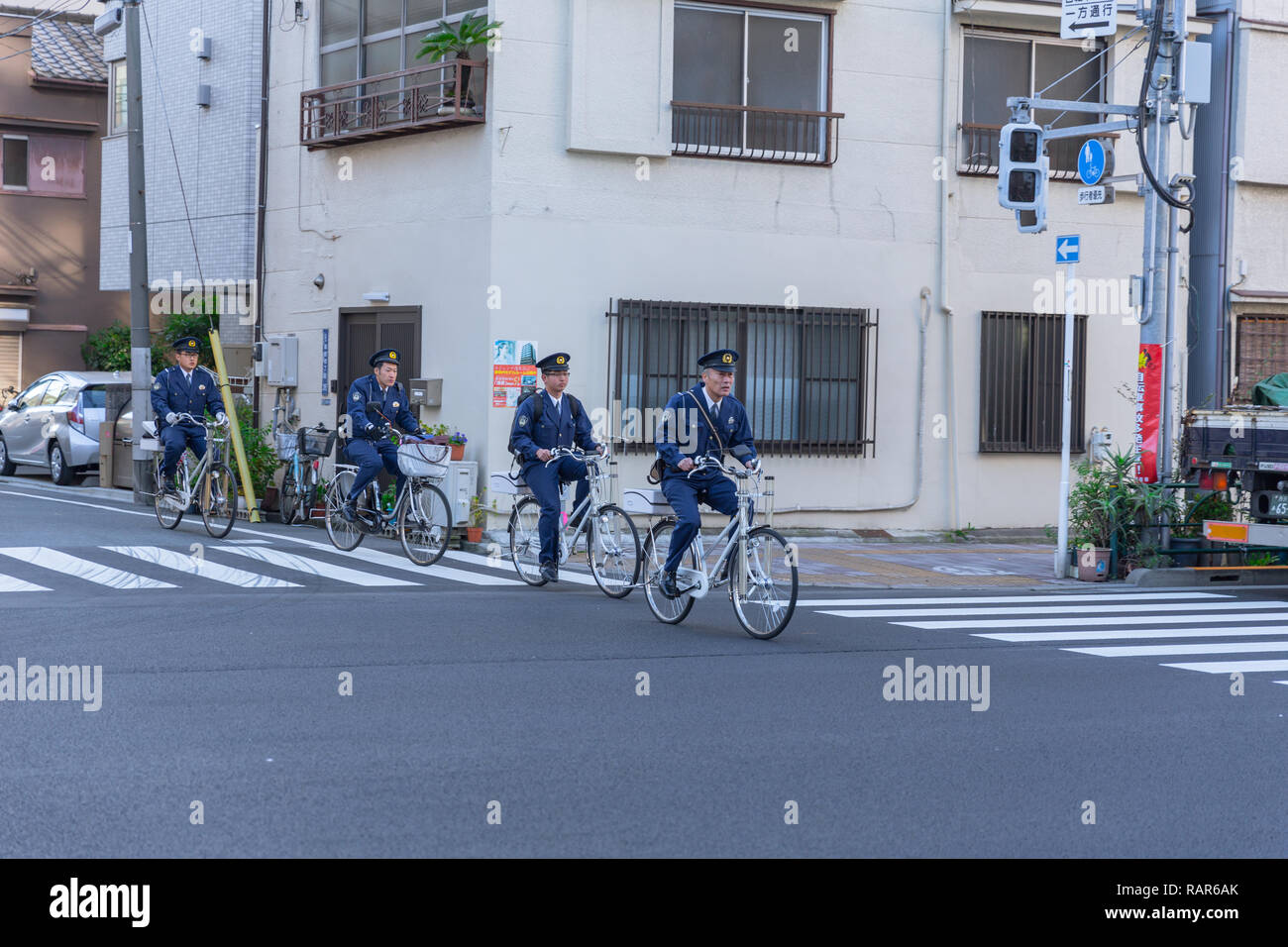 Japanese Police Bicycle Squad Officer Patrolling every morning day duty in Osaka city, Japan, 25 November 2017. Stock Photo
