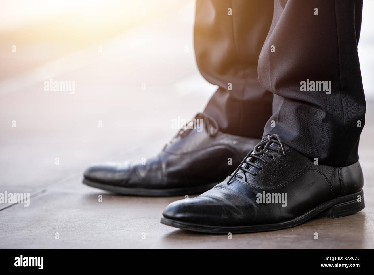 Businessman closeup leather shoes black color clean new shiny standing ready to walk. Stock Photo