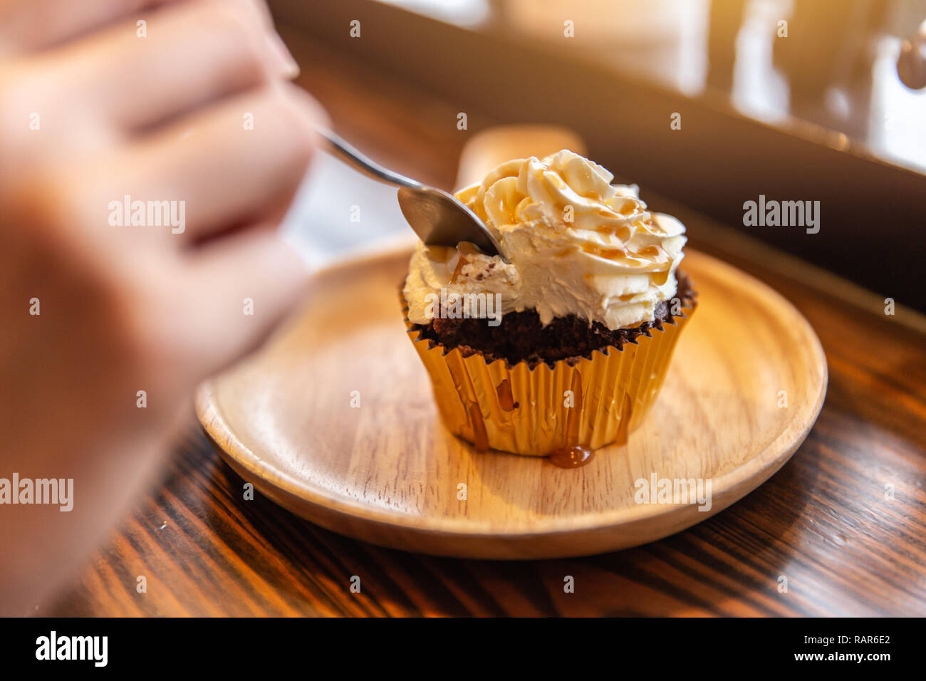 Eating cream cup cake sugar sweet delicious fat unhealthy food. Stock Photo