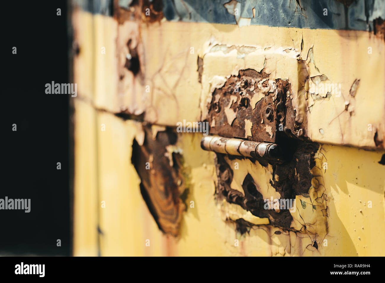 Flaking paint on an old locomotive access panel. Stock Photo