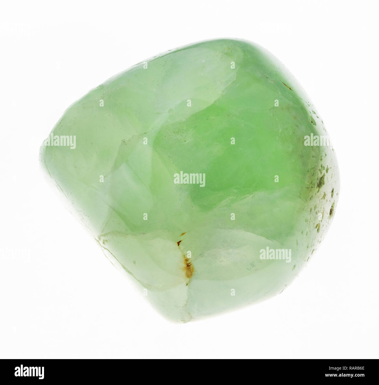 macro photography of natural mineral from geological collection - polished Prehnite gemstone on white background Stock Photo