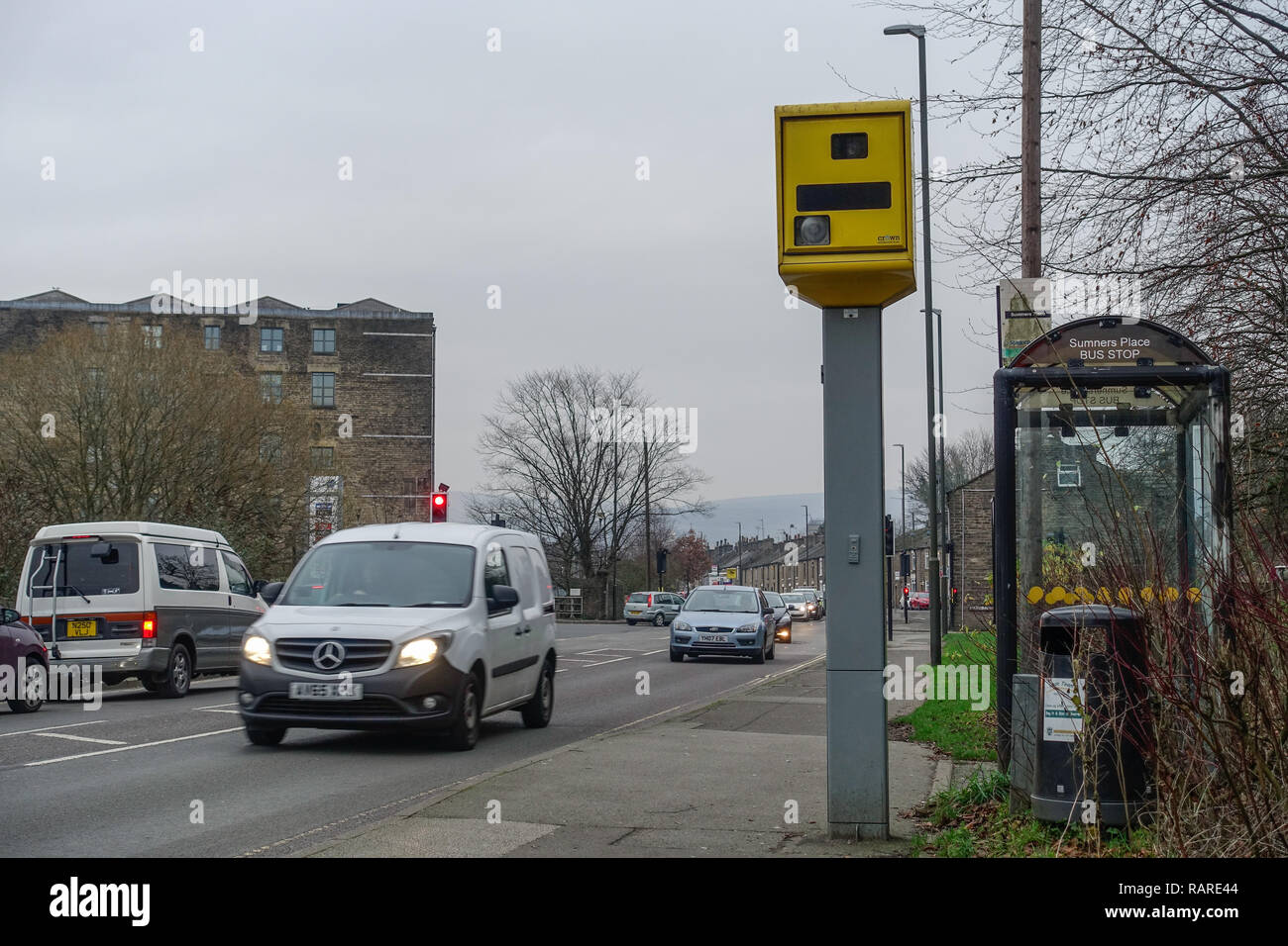 Gatso speed camera and passing lorry and cars on the High Street in Glossop Stock Photo