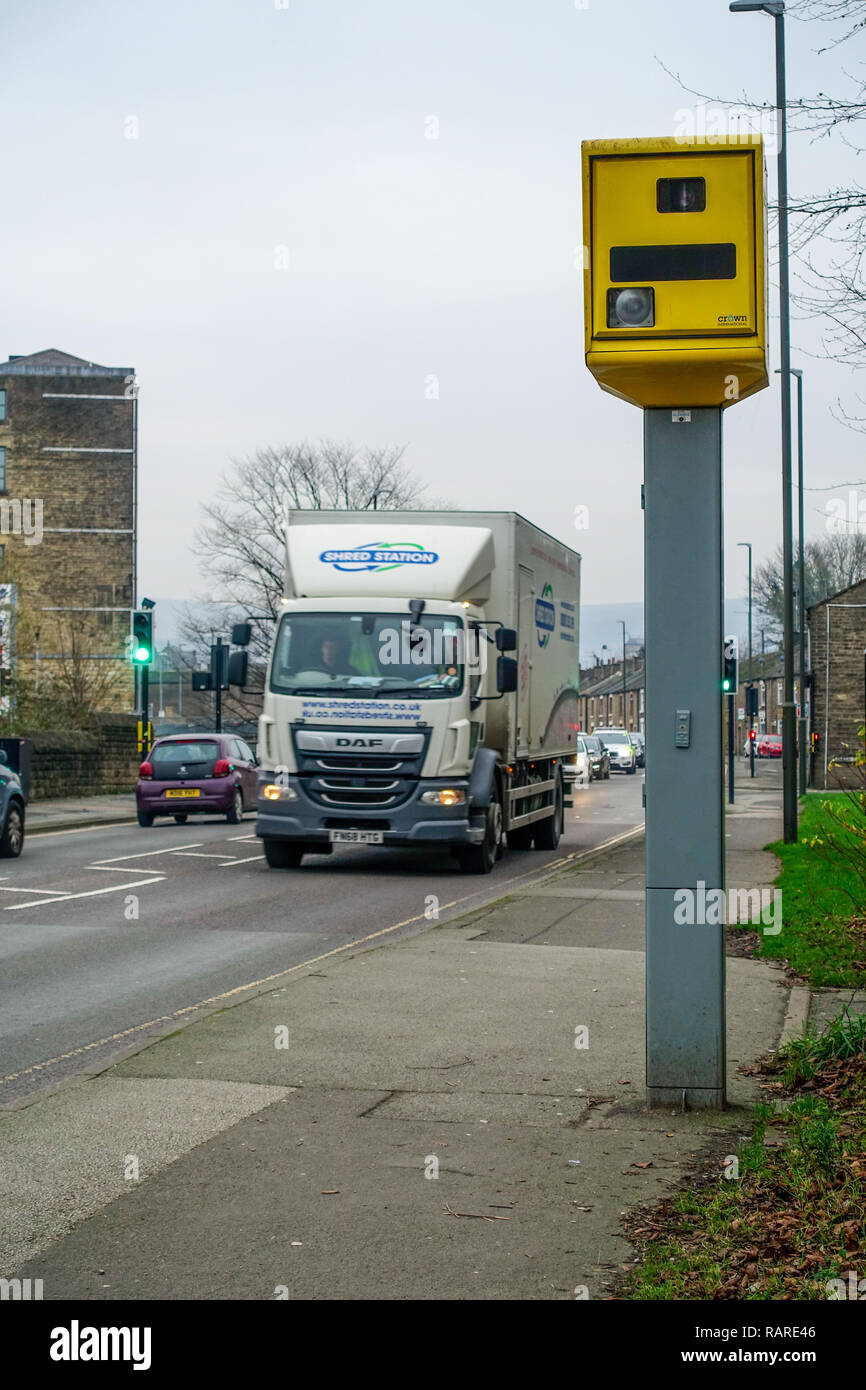 Gatso speed camera and passing lorry and cars on the High Street in Glossop Stock Photo