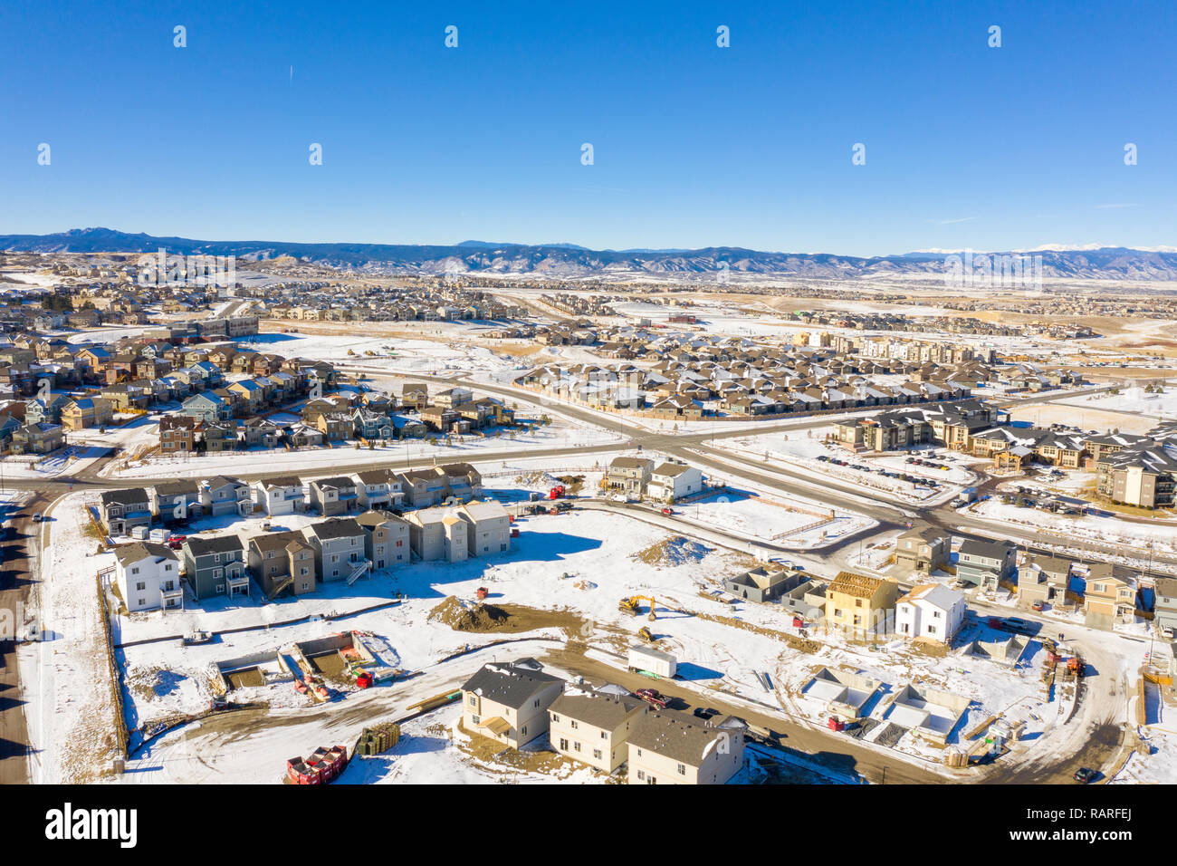 A great photo illustrating the Colorado housing boom as it continues even in the winter snow Stock Photo