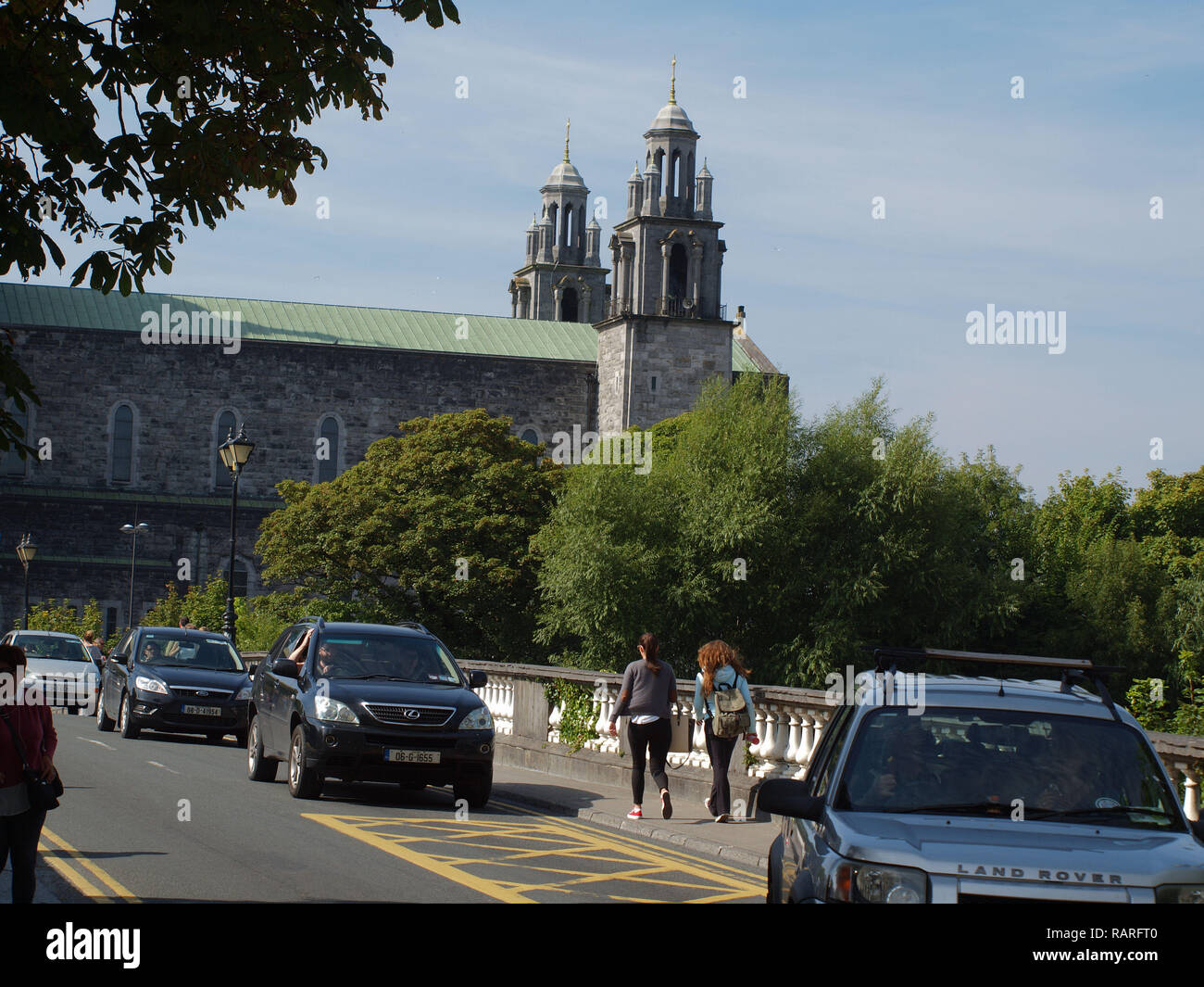 Traffic and pedestrians crossing the 'Salmon Weir Bridge' with Galway