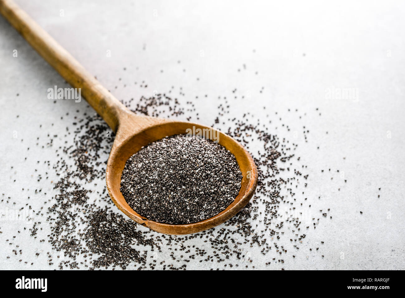 Healthy food, sources omega3 wooden spoon of chia seed on white
