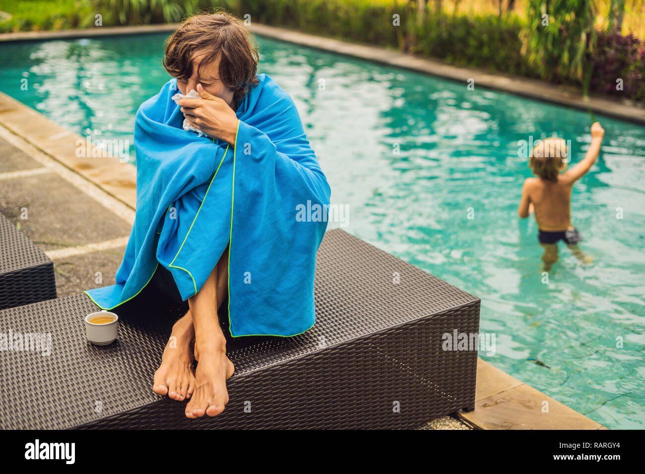 Sick man traveler. The man caught a cold on vacation, sits sad at the