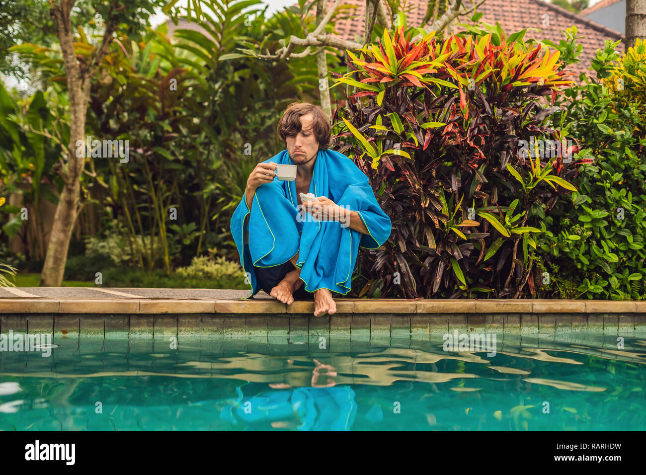 Sick man traveler. The man caught a cold on vacation, sits sad at the