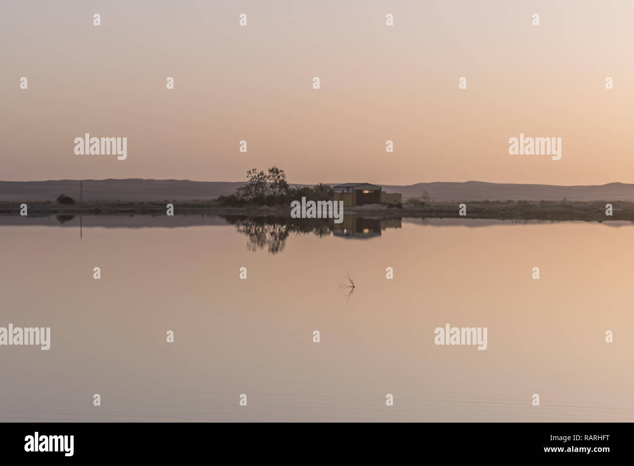 Reflection on calm water in Fatnas Island , Siwa Egypt Stock Photo