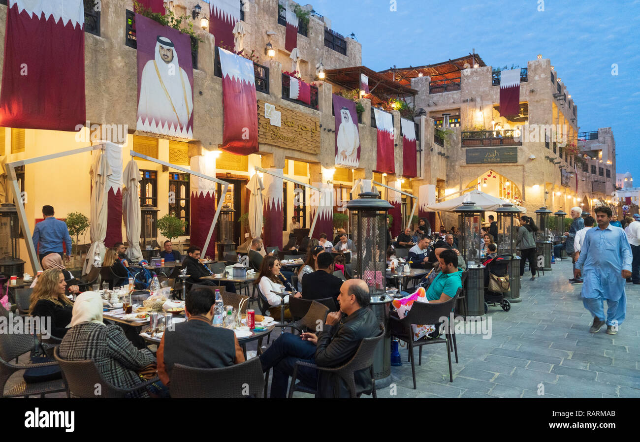 Evening view of street busy with people in Souq Waqif in Doha, Qatar Stock Photo