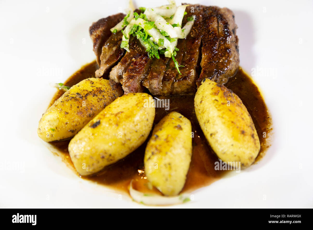 Beef steak served with potatoes in France. The beef has been slices and