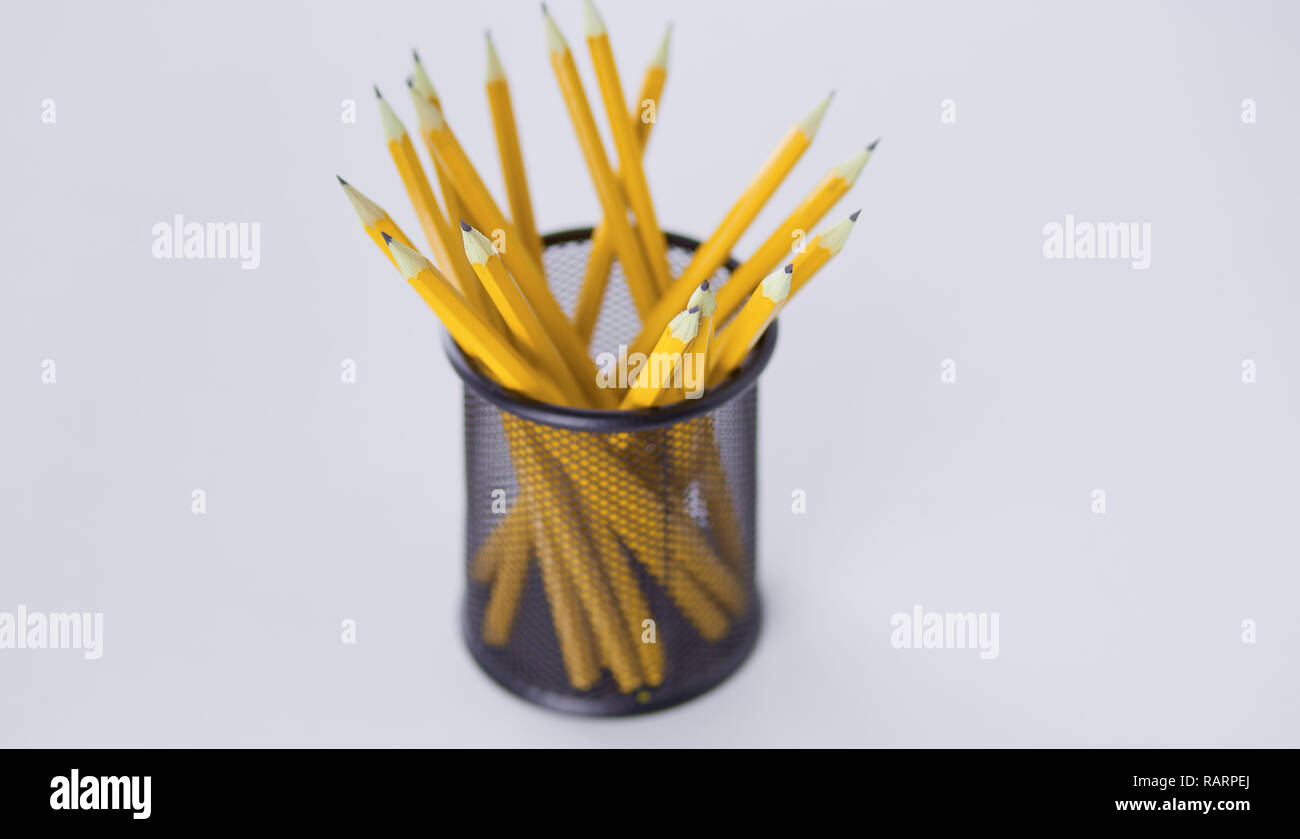 Graphite pencils in a metal grid-container. Concept. Stock Photo