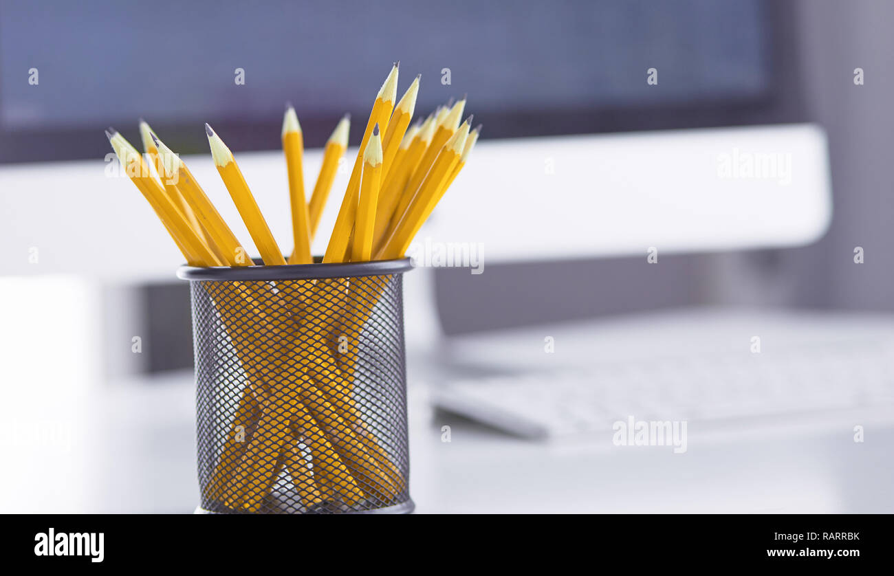 Graphite pencils in a metal grid-container. Concept. Stock Photo