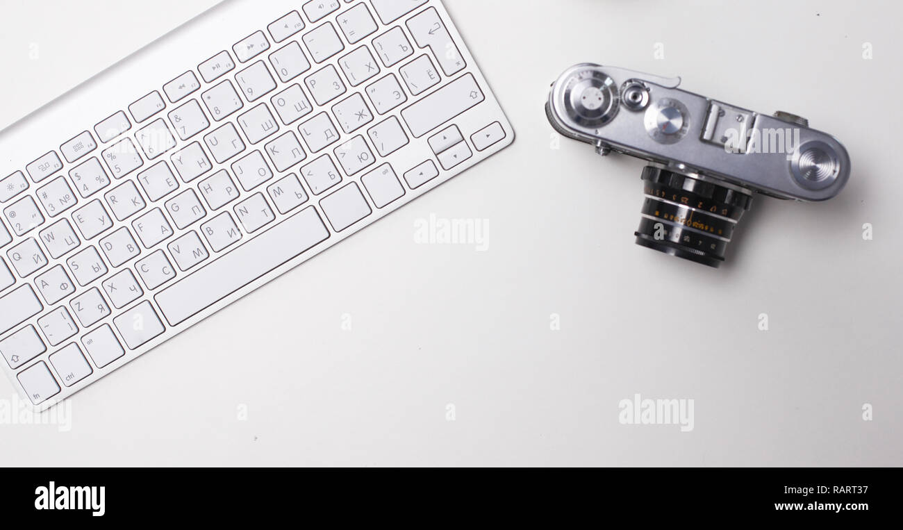 Computer keyboard, mouse and camera lie on table. Stock Photo