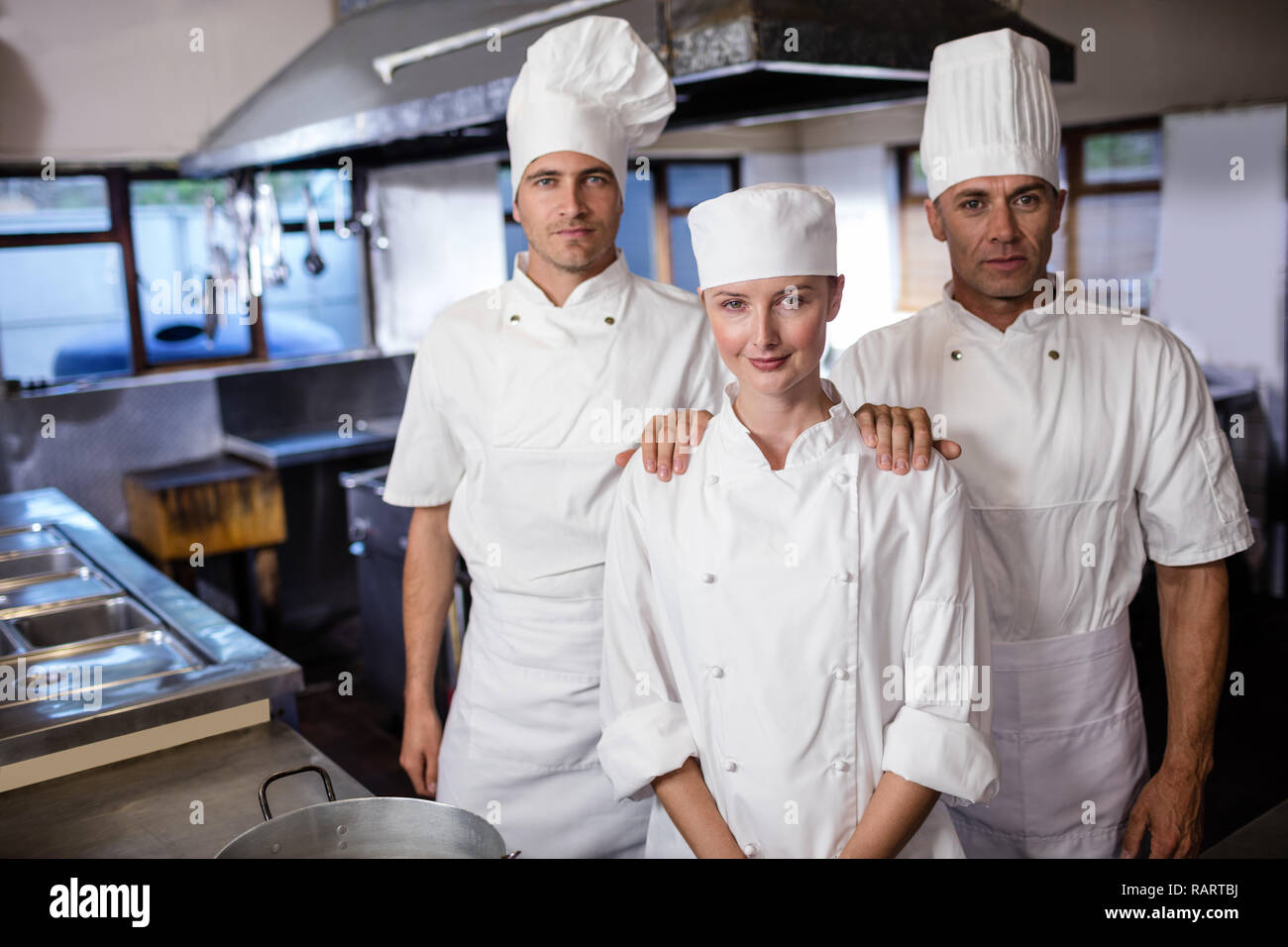Group of chefs standing in kitchen Stock Photo Alamy