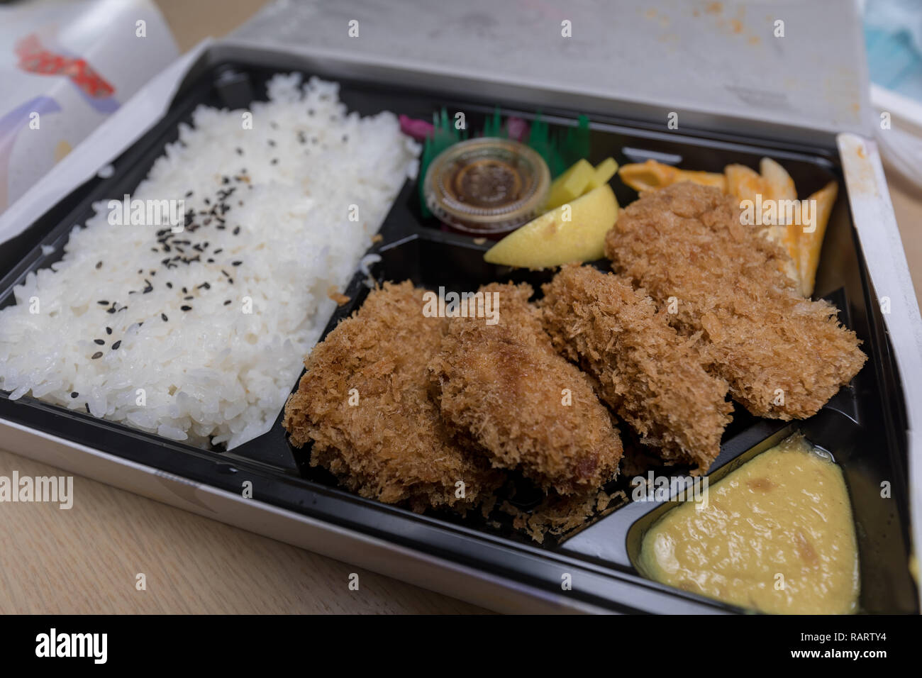 Tonkatsu Bento Served with Japanese Rice Wraped, Cut Tonkatsu (Deep Fried Pork Cutlet) image