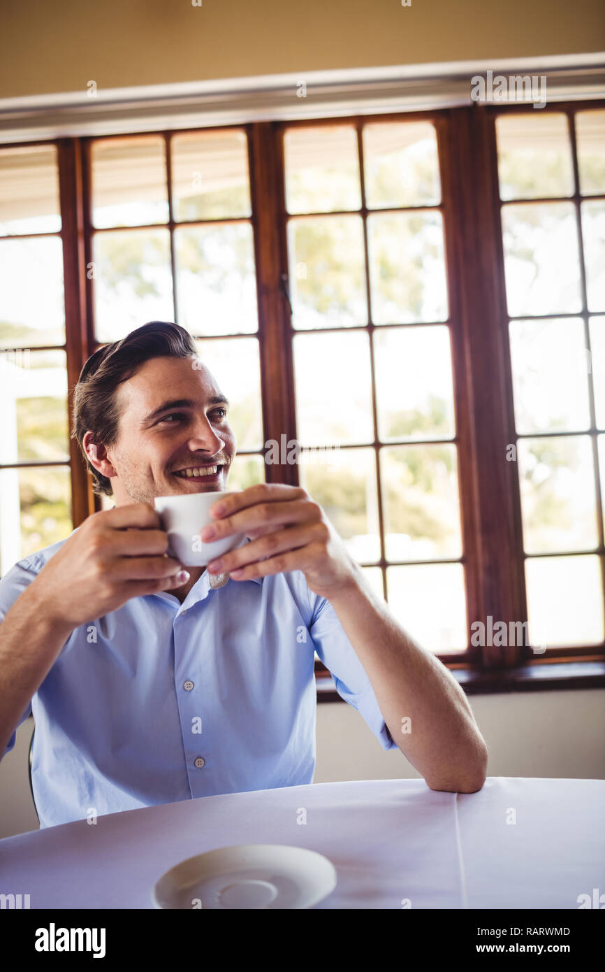 Man having coffee in restaurant Stock Photo